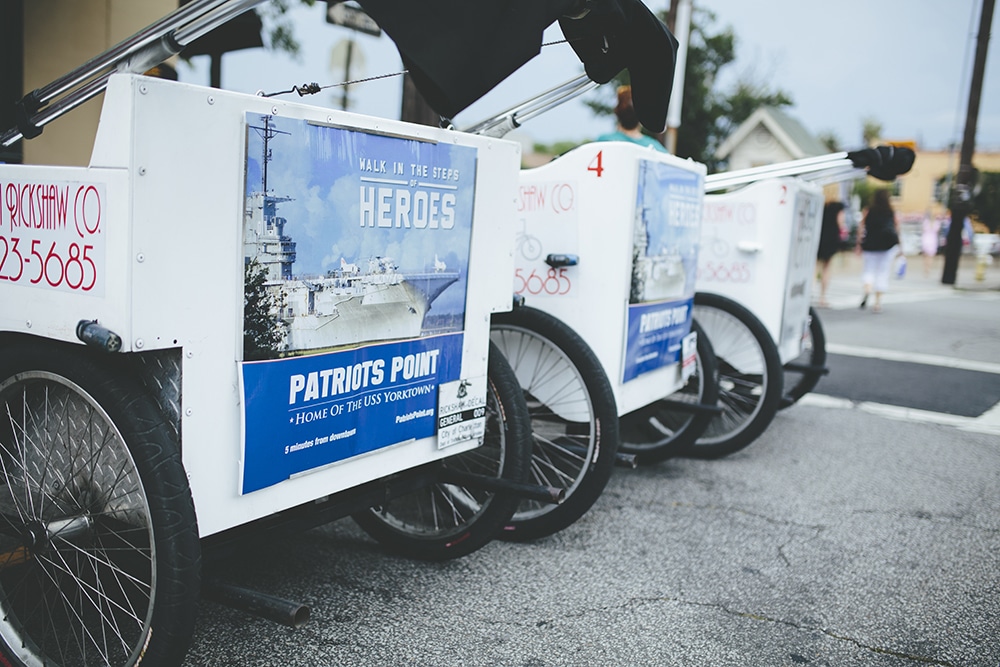 "Walk in the steps of heroes" ads on the back of the Patriots Point Charleston Rickshaw Bikes